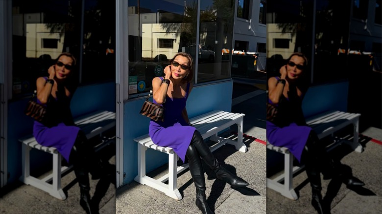 Gym Tan wearing a purple bodycon dress with thigh-high boots