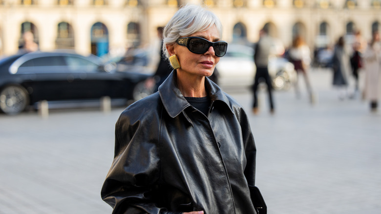 Grece Ghanem poses wearing a black leather jacket and black sunglasses