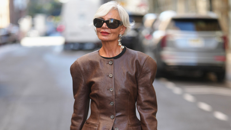 Grece Ghanem wearing a shoulder-padded blazer and bold black sunglasses
