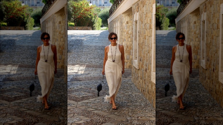 Renia Jaz wearing a cream vest and a sarong-style skirt