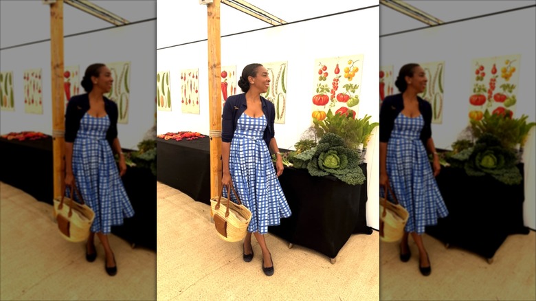 Paula Sutton wearing a checked blue-and-white midi dress and a navy bolero