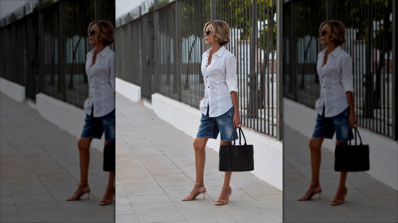 Susi Rejano wearing denim shorts with a white shirt and heels