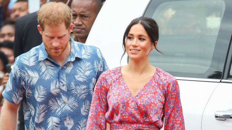 Meghan Markle pictured with Prince Harry wearing a floral maxi dress