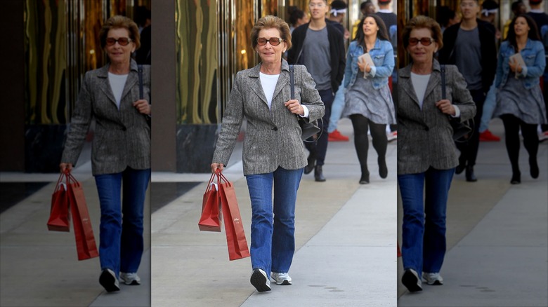 Judy Sheindlin wearing flared jeans and a gray blazer