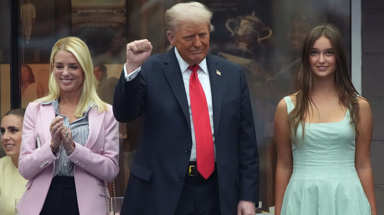 Pam Bondi wearing an unflattering outfit while clapping for Donald Trump