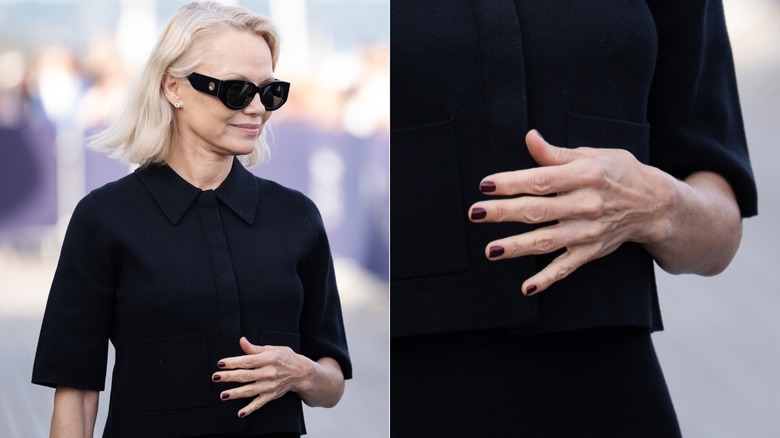 Pamela Anderson wears all black with black sunglasses and a black-cherry manicure.