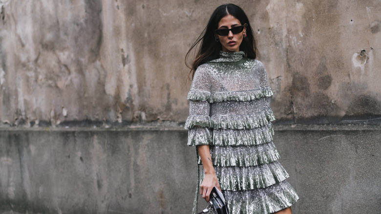 Girl wearing a metallic dress at fashion week.