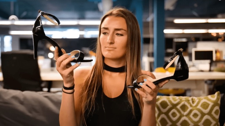 Woman holding Pashion Footwear shoes