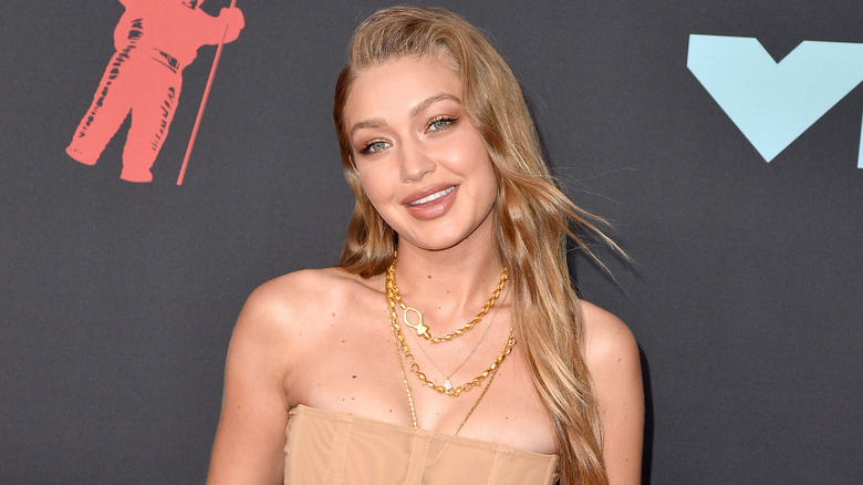 Gigi Hadid posing by media wall