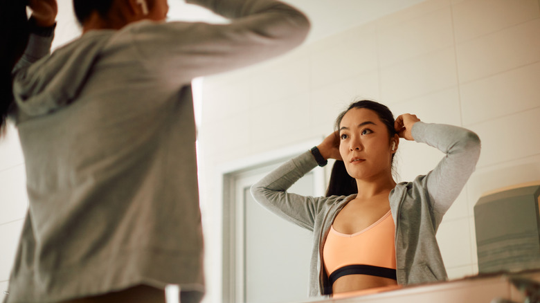 Woman holding hair in ponytail