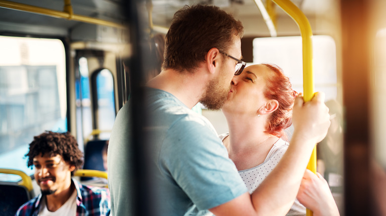 couple kissing on bus