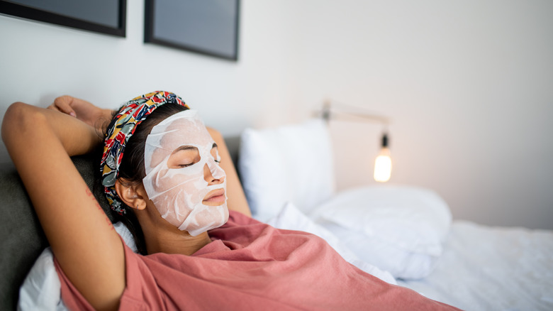 Woman laying down with a face mask