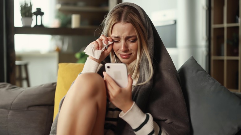 woman crying with phone