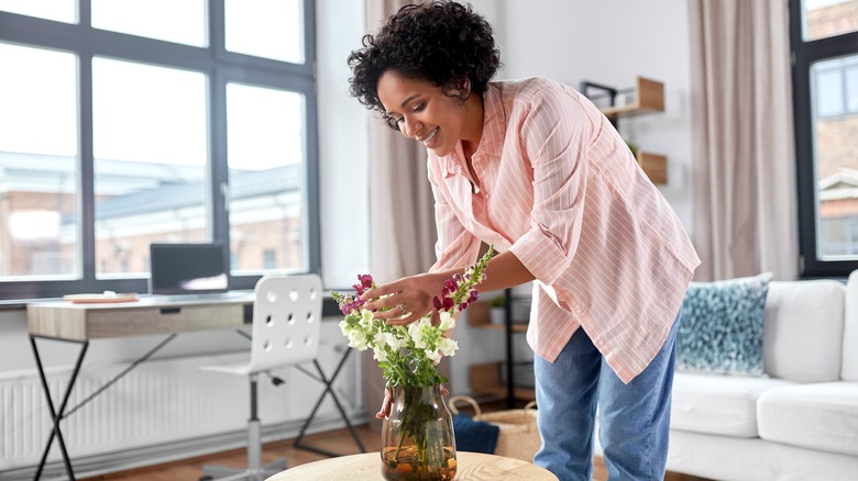 Woman arranges flowers