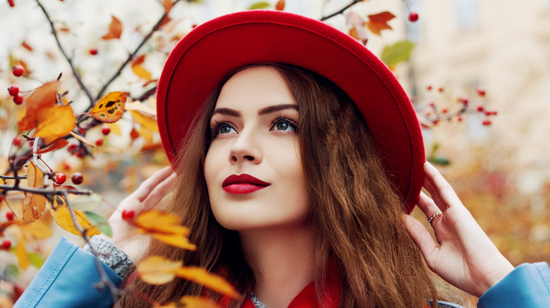 Beautiful young woman enjoying autumn