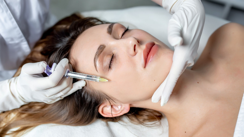 Woman receiving facial injections