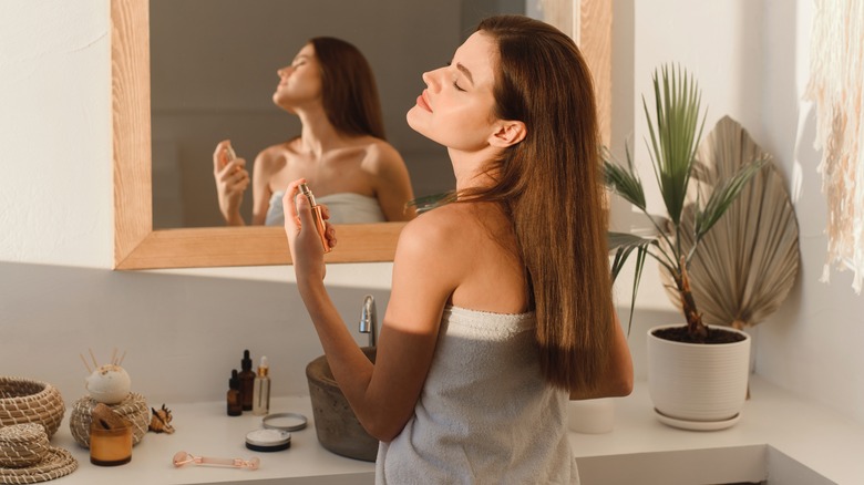 woman applying perfume