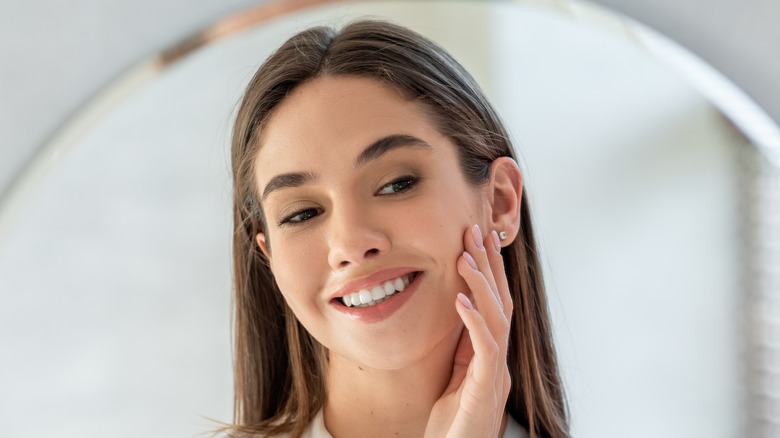 woman looking at skin 