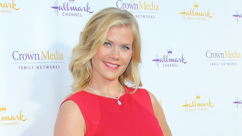 Alison Sweeney wears a red dress and her blond hair down in waves at the Summer TCA Party for the Hallmark Channel in July of 2014 in Beverly Hills, California.