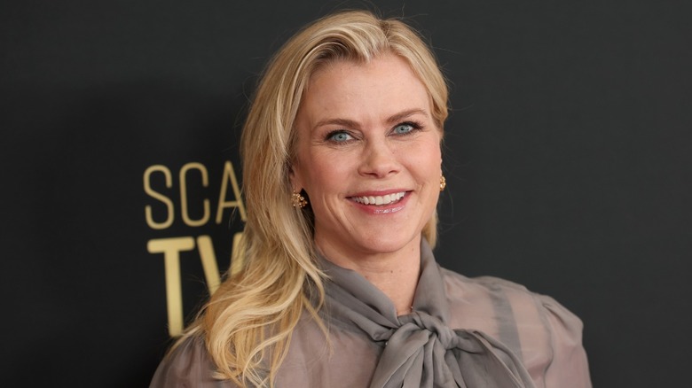 Alison Sweeney poses on the red carpet in a sheer long-sleeve gray blouse with her blond hair down in waves at the Hallmark's Power of Love panel during the 14th SCAD TVfest in Atlanta, Georgia in February 2026.