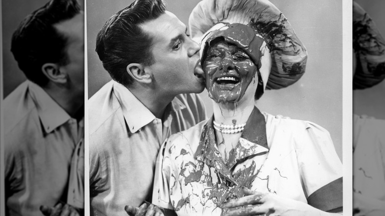 Desi Arnaz and Lucille Ball with chocolate on her face