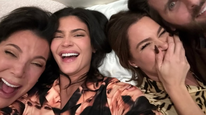 Kylie Jenner with a natural makeup look, laughing at a famiy sleepover