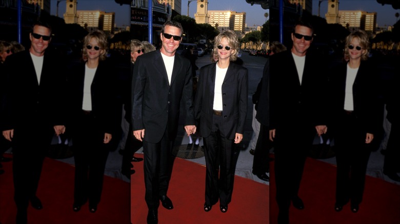 Dennis Quaid posing with Meg Ryan at a red carpet event in matching suits.