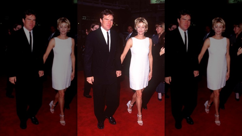 Dennis Quaid in a suit pictured walking with Meg Ryan wearing a white shift dress at a red carpet event.