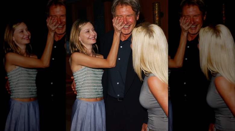 Calista Flockhart playfully puts her hand on Harrison Ford's face