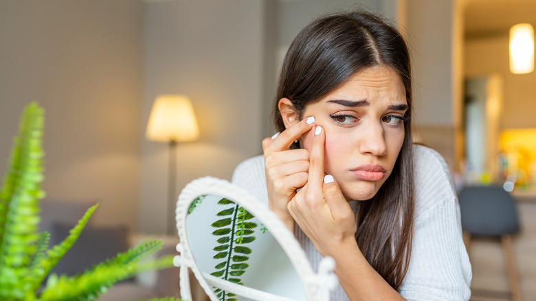 Woman popping her pimple