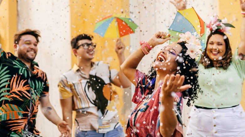 Adults smiling and throwing confetti
