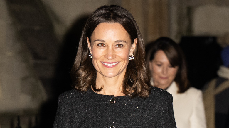 Pippa Middleton smiling in a dark top
