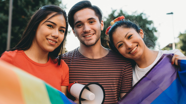 polyamorous couple with pride flag