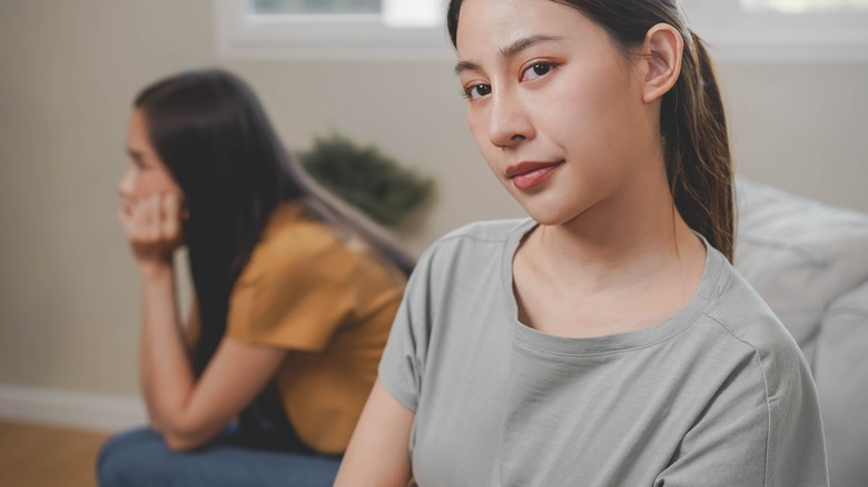 Two women sitting on couch