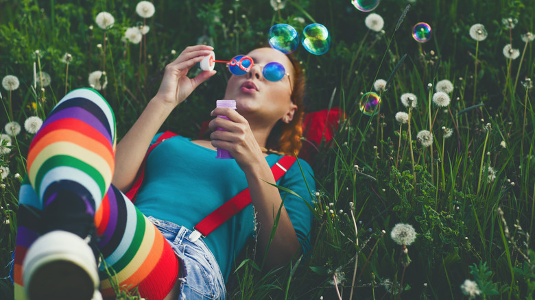 woman blowing bubbles