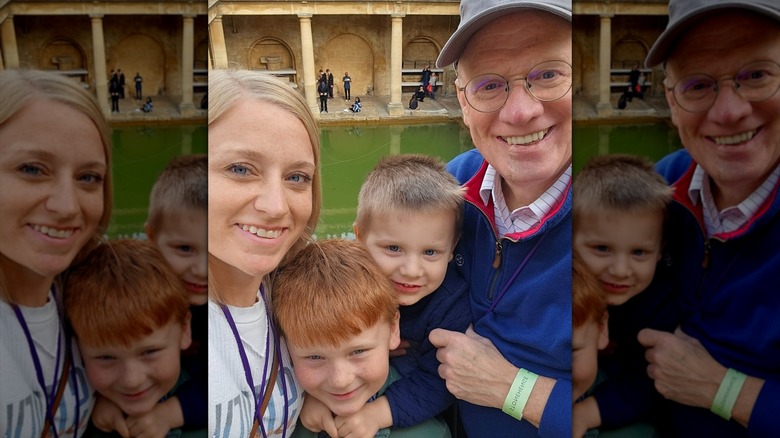 John and Chelsea Rose posing in bath with their two kids
