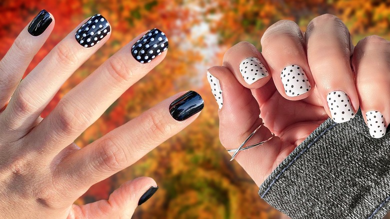 Hands with polka-dot nails, fall backdrop
