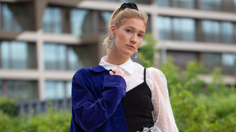 woman holding cobalt blazer