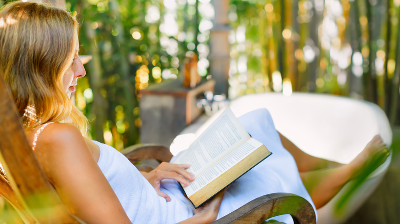 Woman reading book outdoors