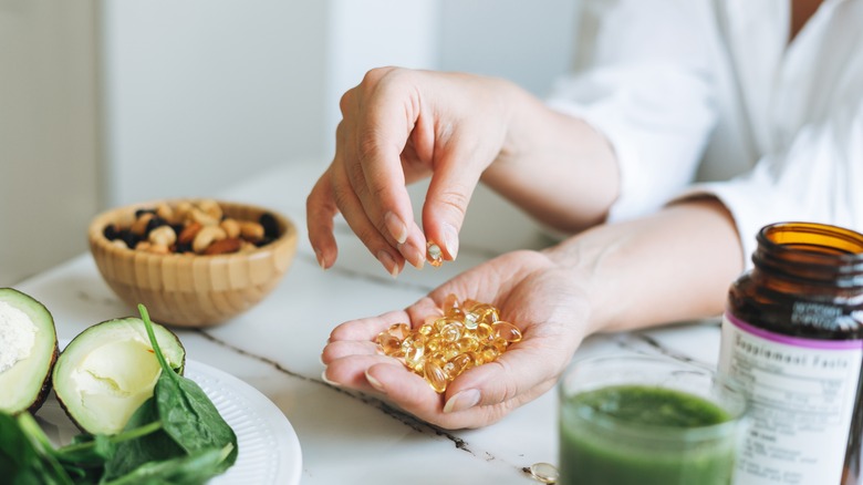 woman with vitamins and healthy food