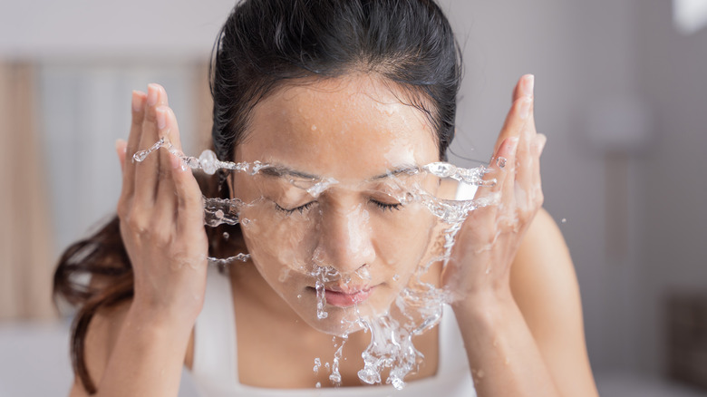 woman washing her face