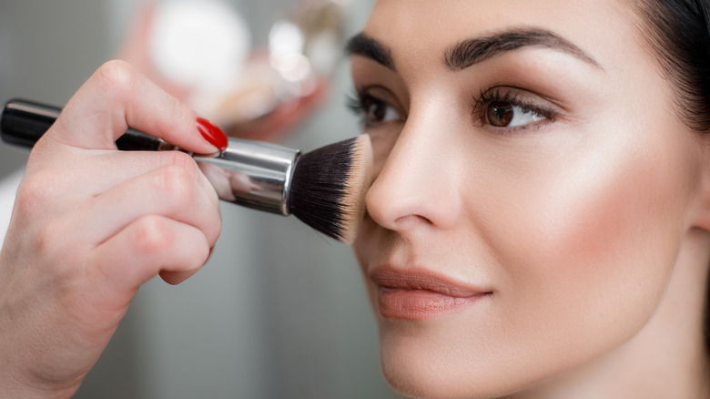 woman getting her makeup done