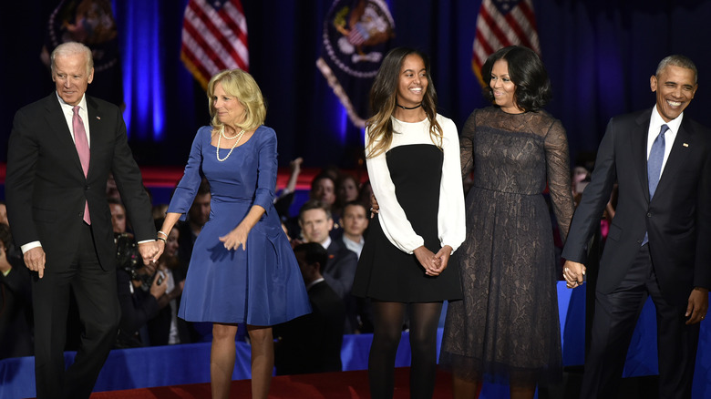 obama and biden families standing on stage