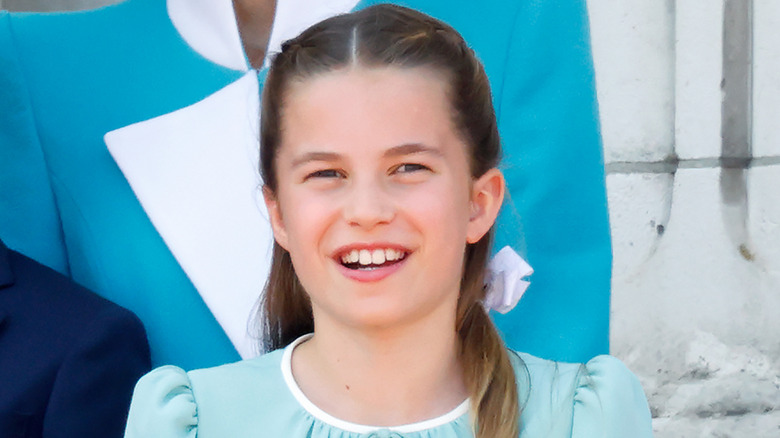 Princess Charlotte smiles in a blue dress