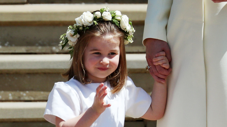 Princess Charlotte smiles in a white dress