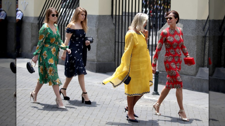 Princess Eugenie and Princess Beatrice in floral dresses at a wedding in Peru