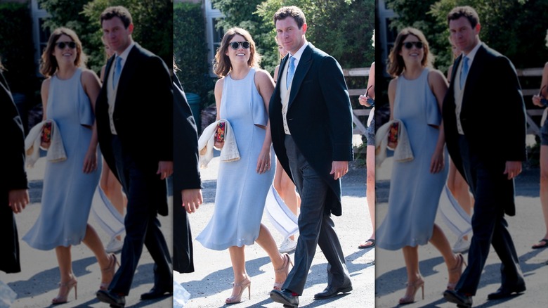 Princess Eugenie wearing a blue dress as she walks with Jack Brooksbank