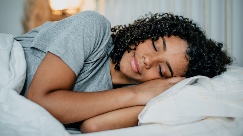 Smiling woman sleeping in bed