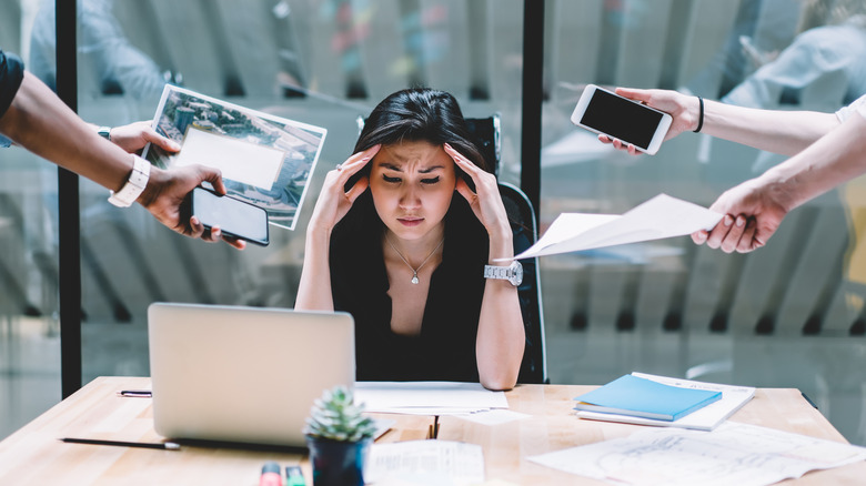 Overwhelmed woman at work