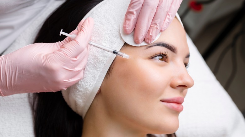 Woman receiving cosmetic treatment